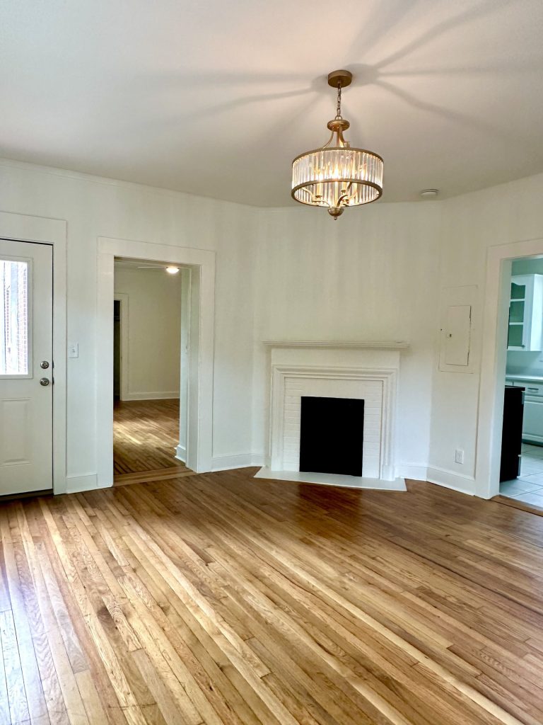 Unit 3 room with hardwood floors and a fireplace at 715 1st St SE Apartments