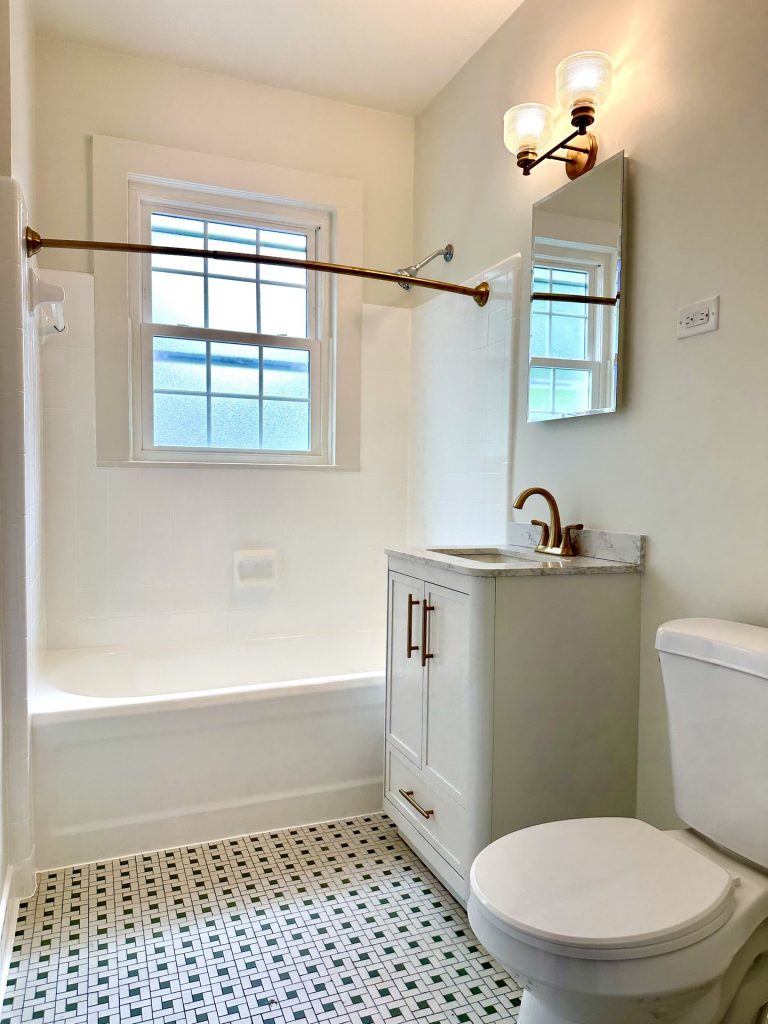 Bathroom with tub and vanity in Unit 5 at 715 1st St SE Apartments