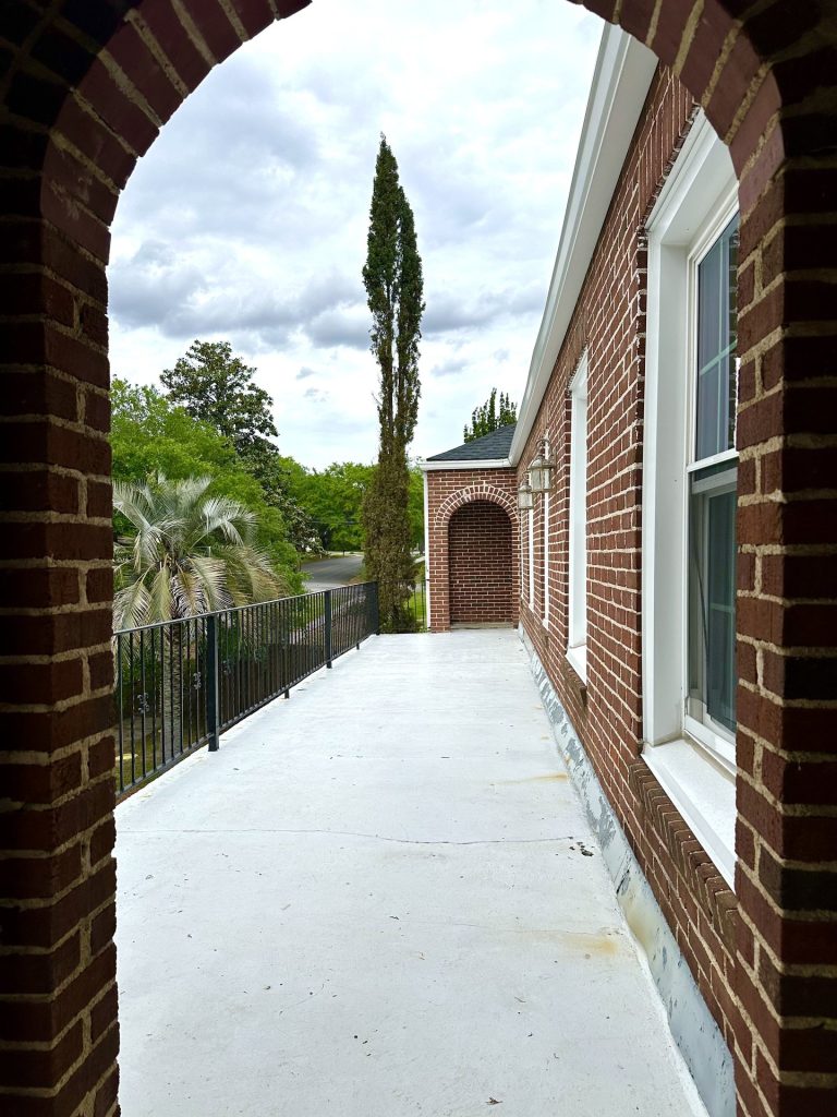 Covered brick porch outside Unit 5 at 715 1st St SE Apartments
