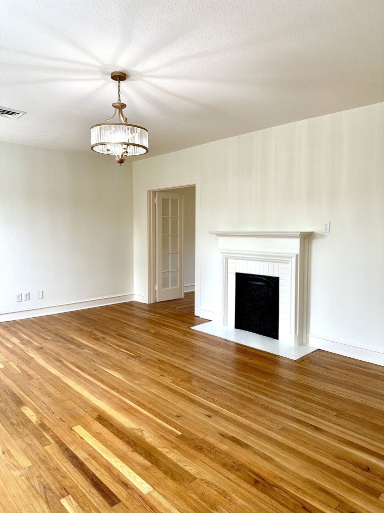 Unit 5 room with hardwood floors and a fireplace at 715 1st St SE Apartments
