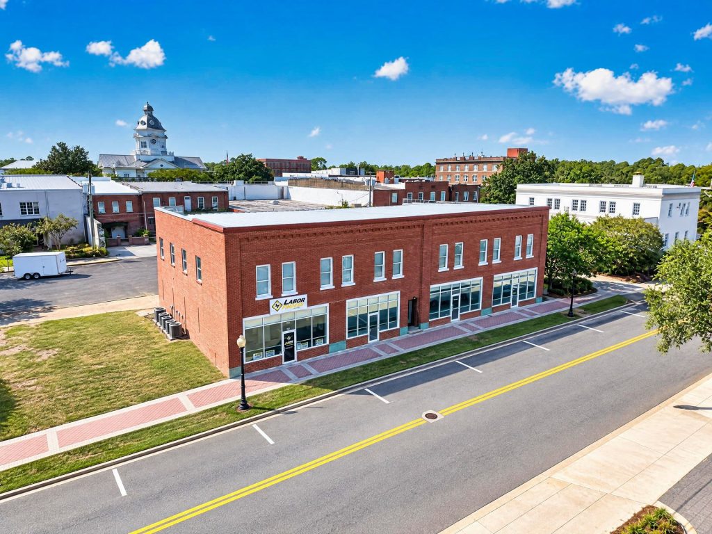 Colquitt Lofts brick exterior with residential lofts above the ground-floor commercial spaces, Moultrie, GA